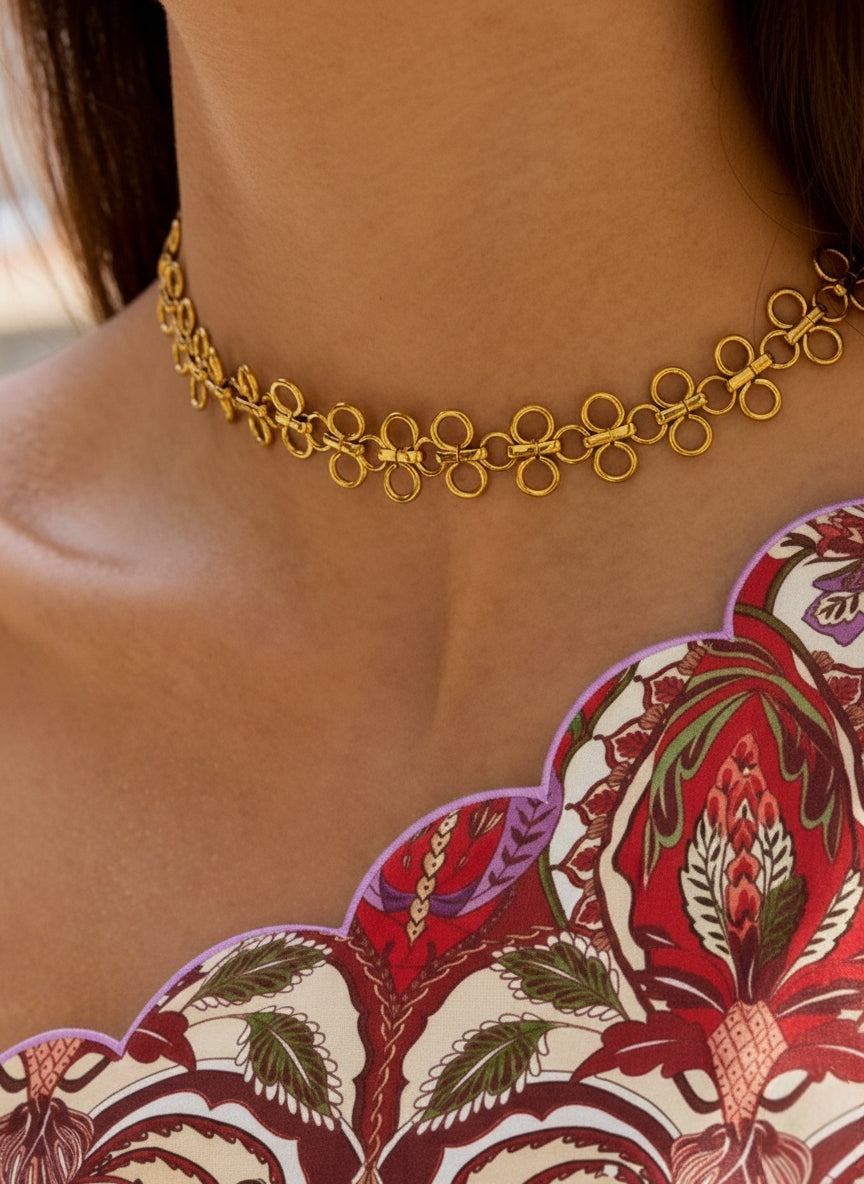 Een model draagt de goudkleurige filigraan choker ketting. De ketting wordt gecombineerd met een top.